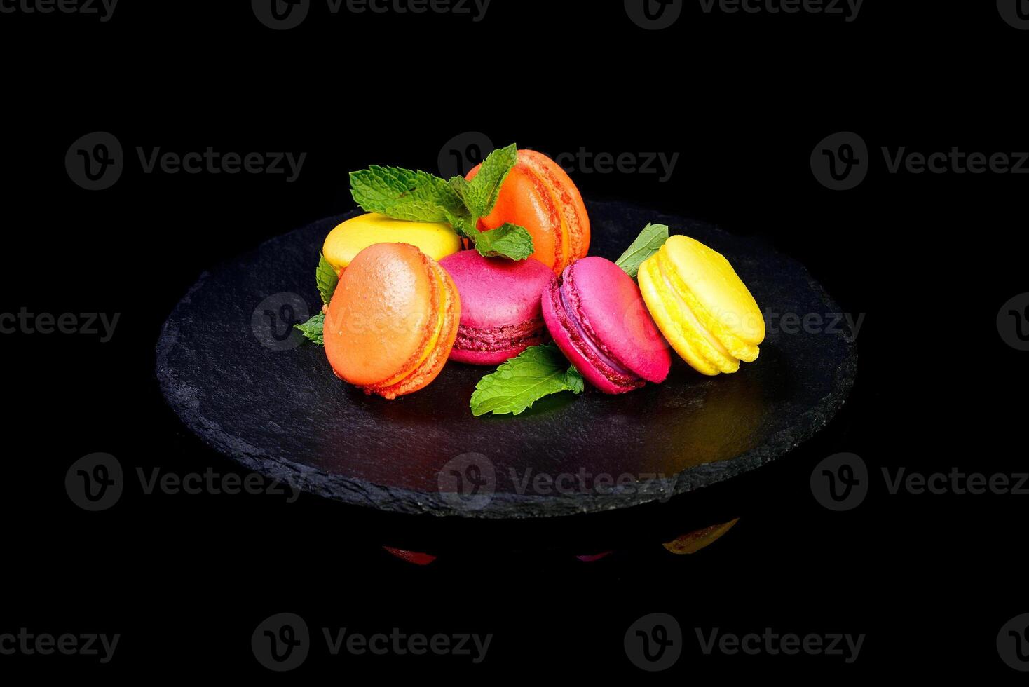 Colorful macarons on slate plate photo