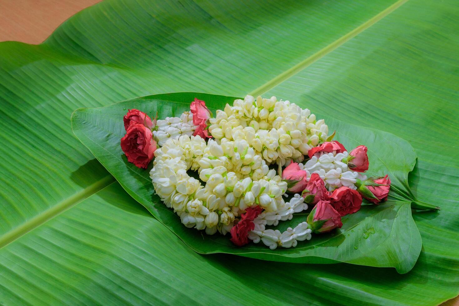 Thai traditional jasmine garland.symbol of Mother's day in thailand on leaf Banana photo