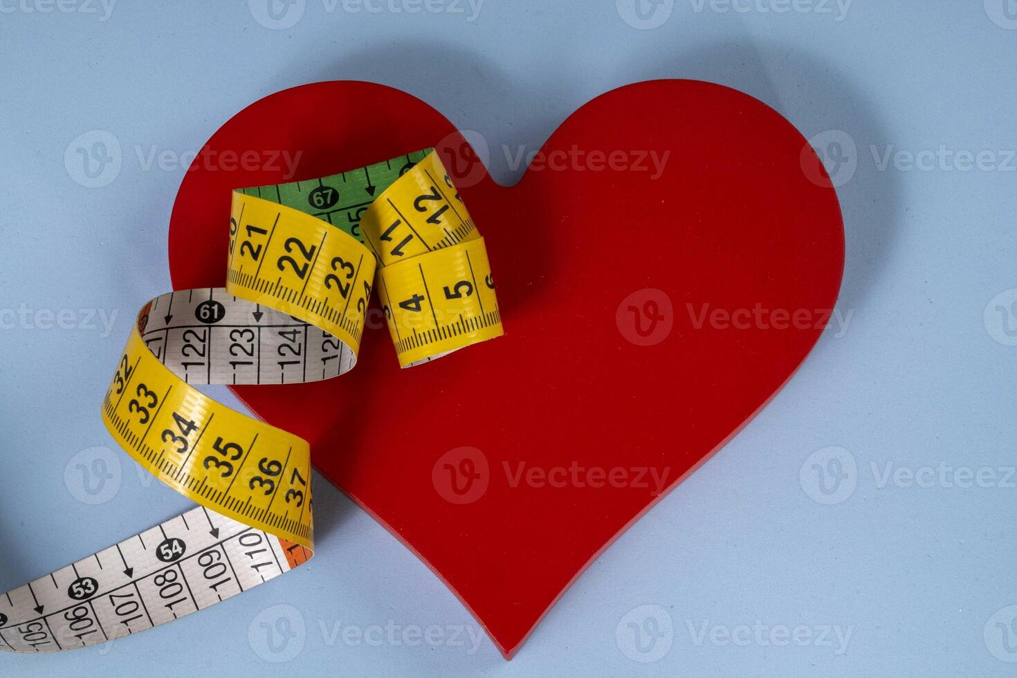A red heart shape with measuring tape symbolizing health care photo