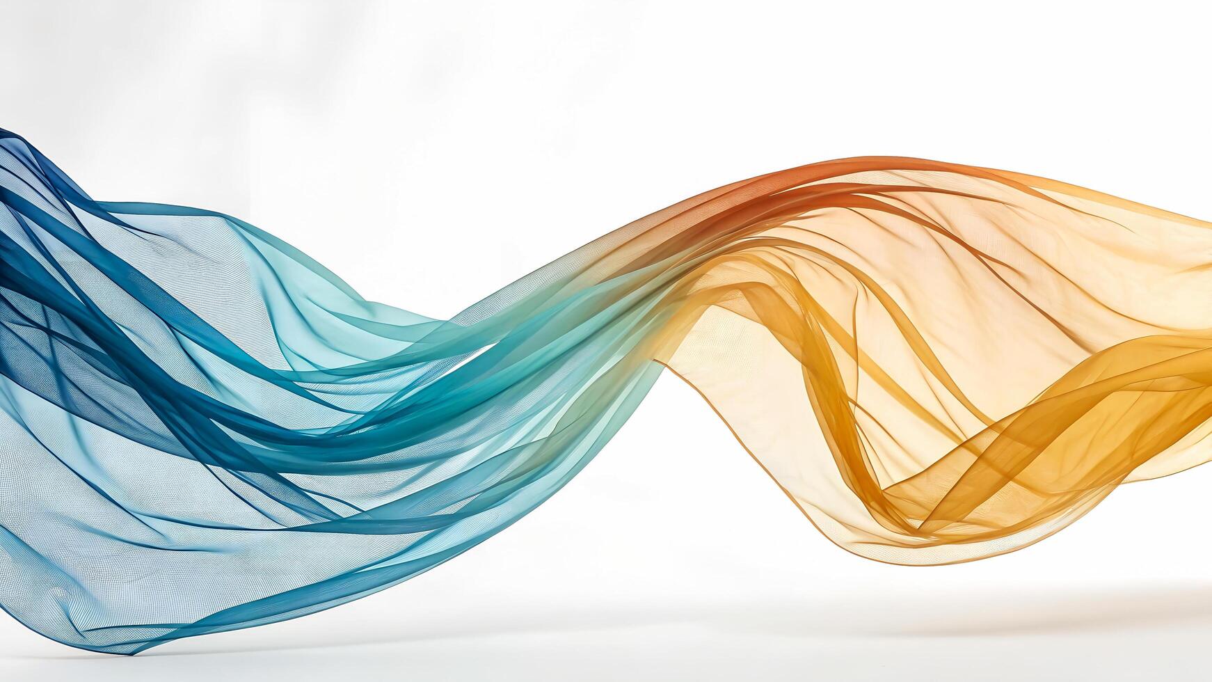 Flowing sheer fabric transitions from deep blue to warm orange against a white background photo