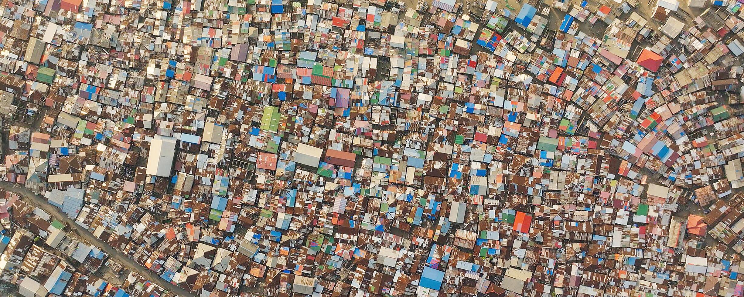 Dense urban area viewed from above, showing colorful rooftops. photo