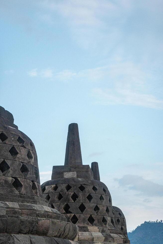 Close up Stone Stupa of Borobudur Temple with Clear Sky Scenery photo