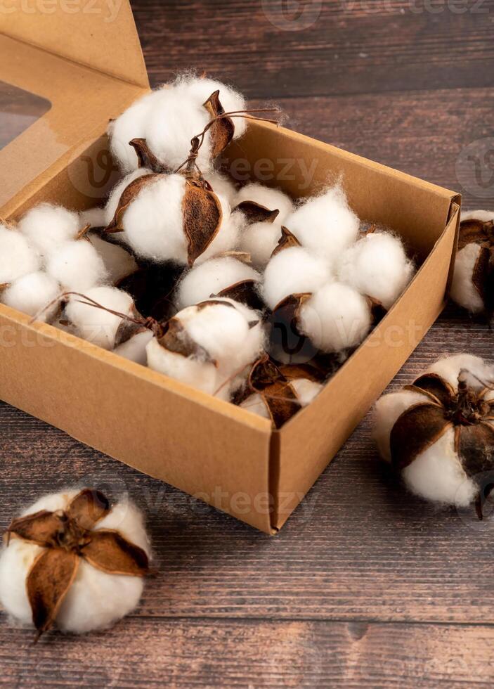 Artificial cotton buds in a craft box, great for autumn handmade decor or gift wrapping. Simple and rustic design for seasonal charm photo