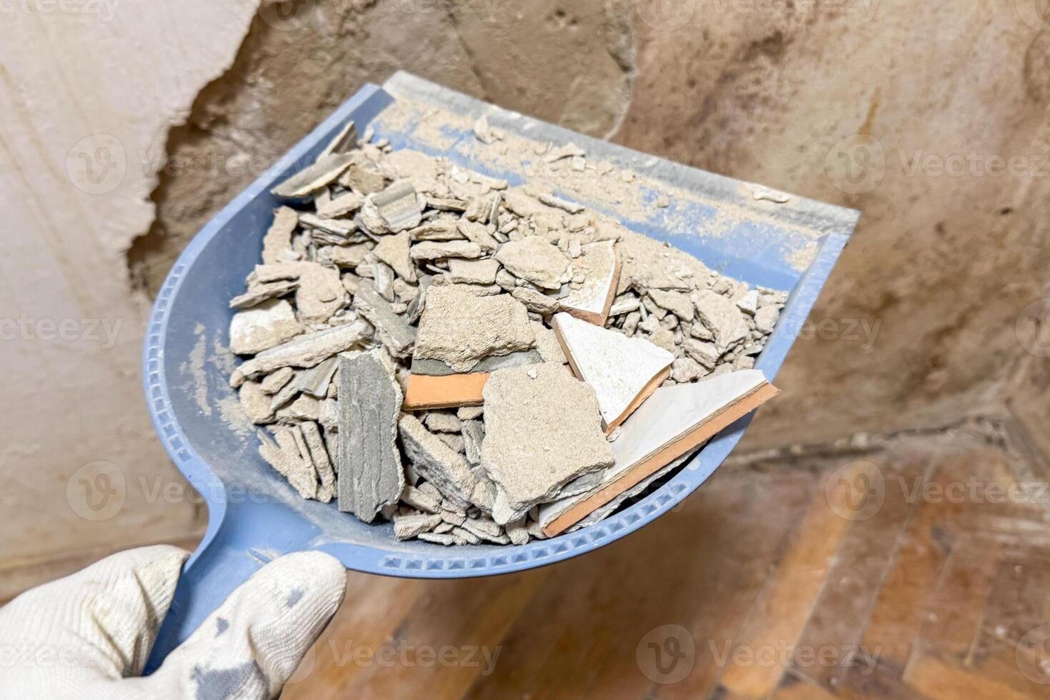 Dustpan cradles shattered dreams of renovation with a mosaic of plaster and timeworn tiles fitting for World Habitat Day photo