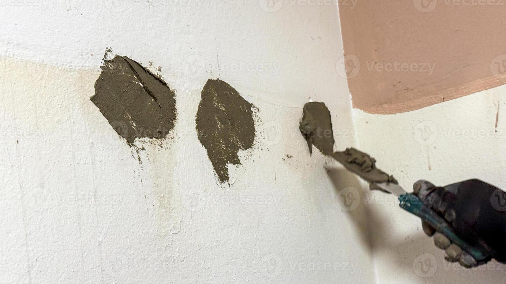 Trowel smears of fresh plaster on textured wall evoke craftsmanship rebirth, DIY marvels akin to Patching Day rituals photo