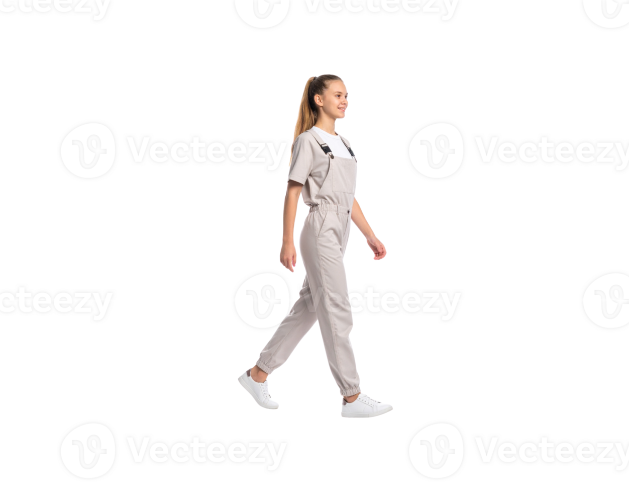 Woman in Beige Overalls Walking with Ponytail and White Sneakers. png
