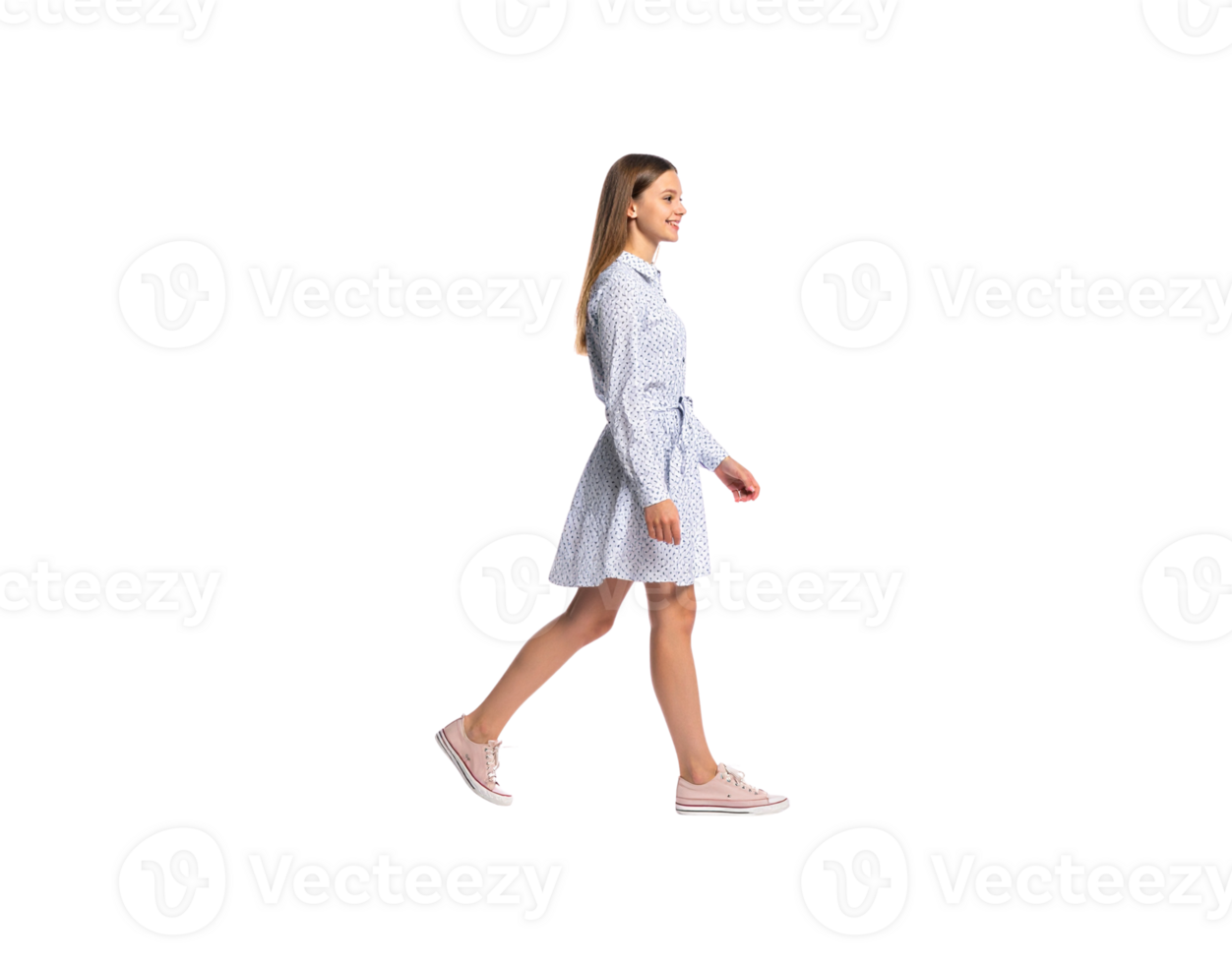 Smiling Woman Walking in a Patterned Dress and Pink Sneakers. png