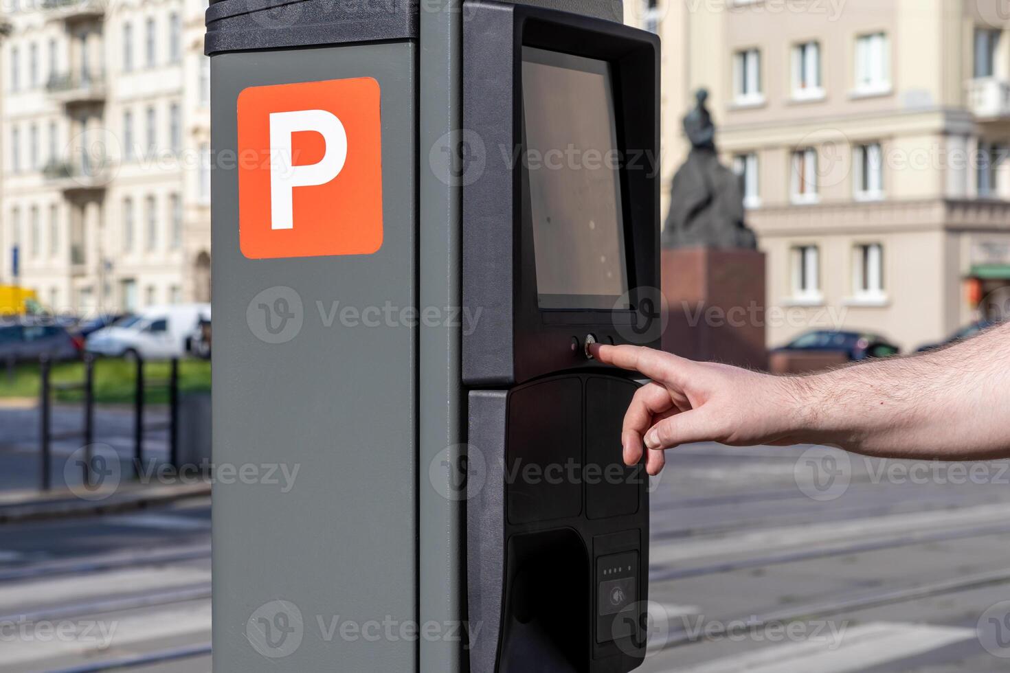 Human hand operates a modern city parking meter displaying an orange P sign for street payment, emphasizing urban mobility and efficient public service technology photo