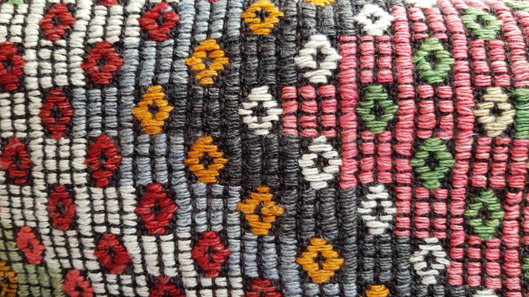 Weave texture of traditional Turkish ethnic pattern carpet closeup photo