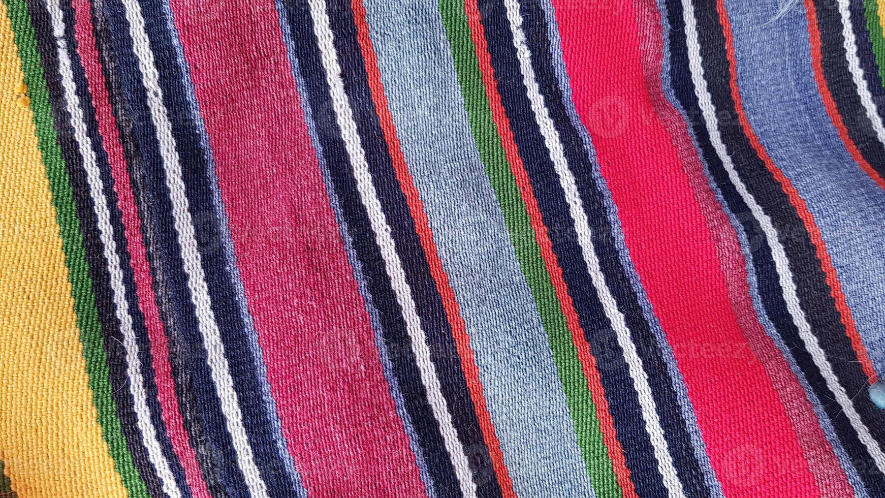 Texture of traditional Turkish ethnic striped carpet closeup photo