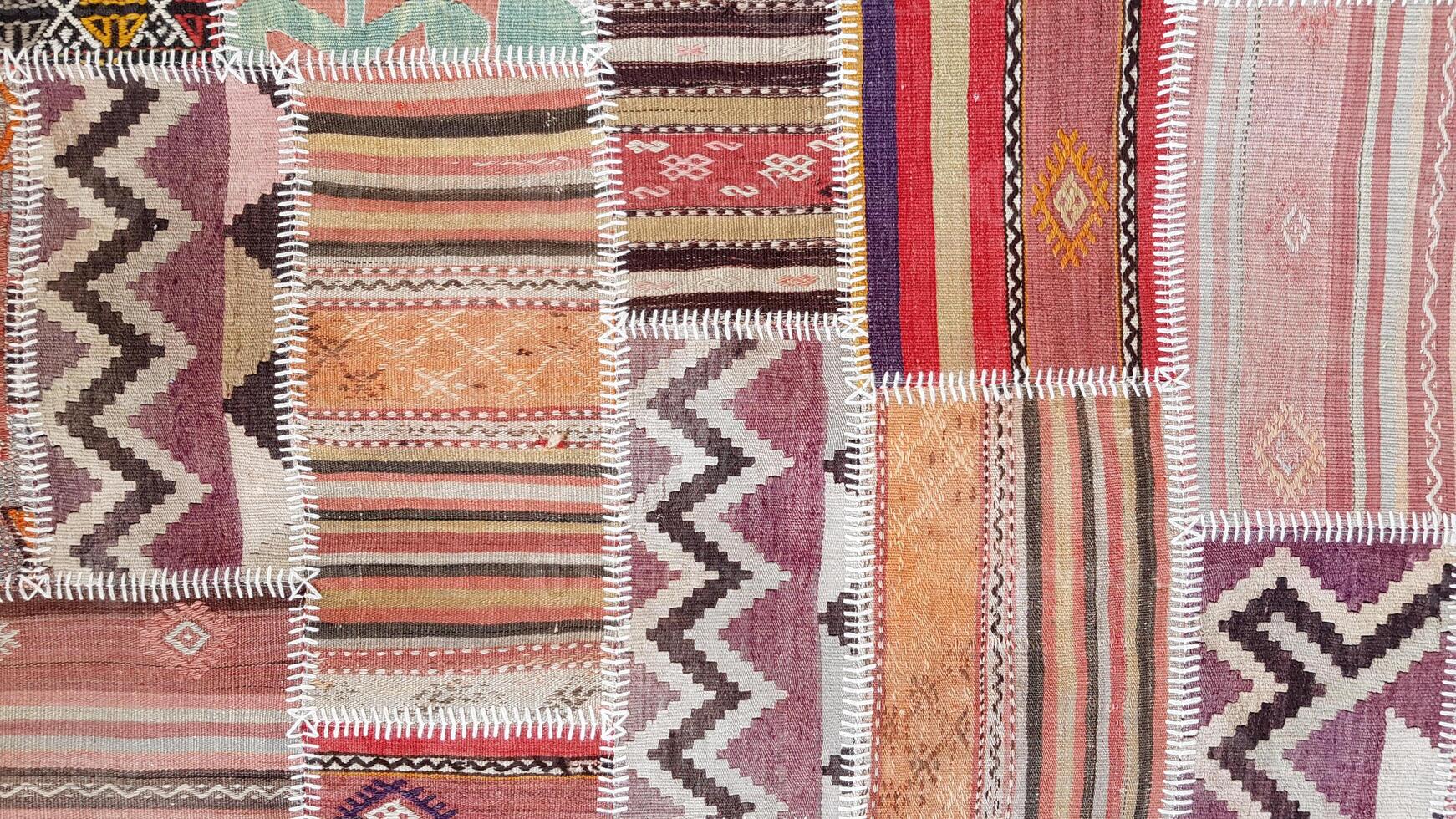 Patch texture of traditional Turkish ethnic patterned carpet closeup photo