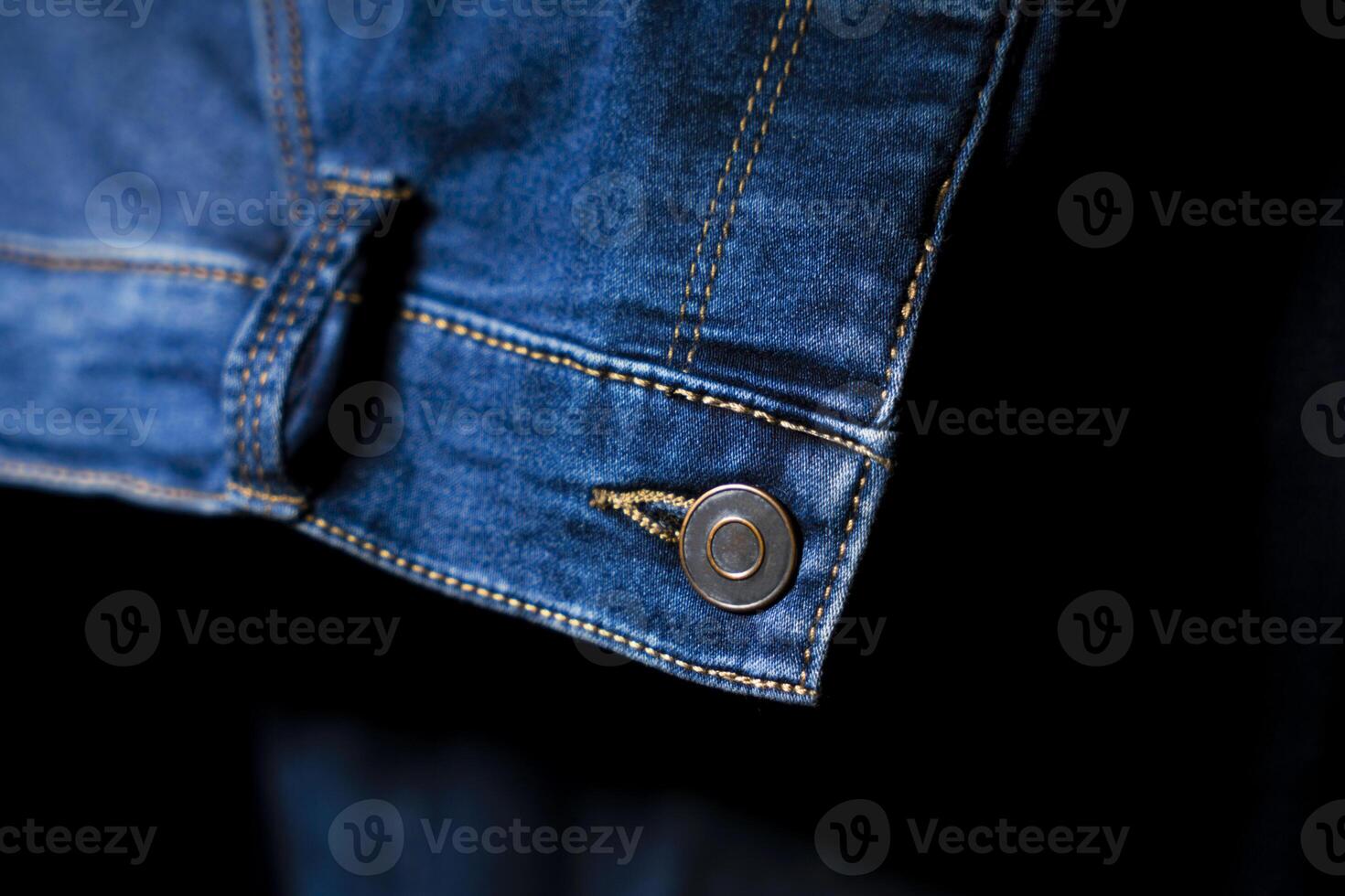 Close-Up of Button and stitching on Blue Jeans, Detailed Denim Design photo