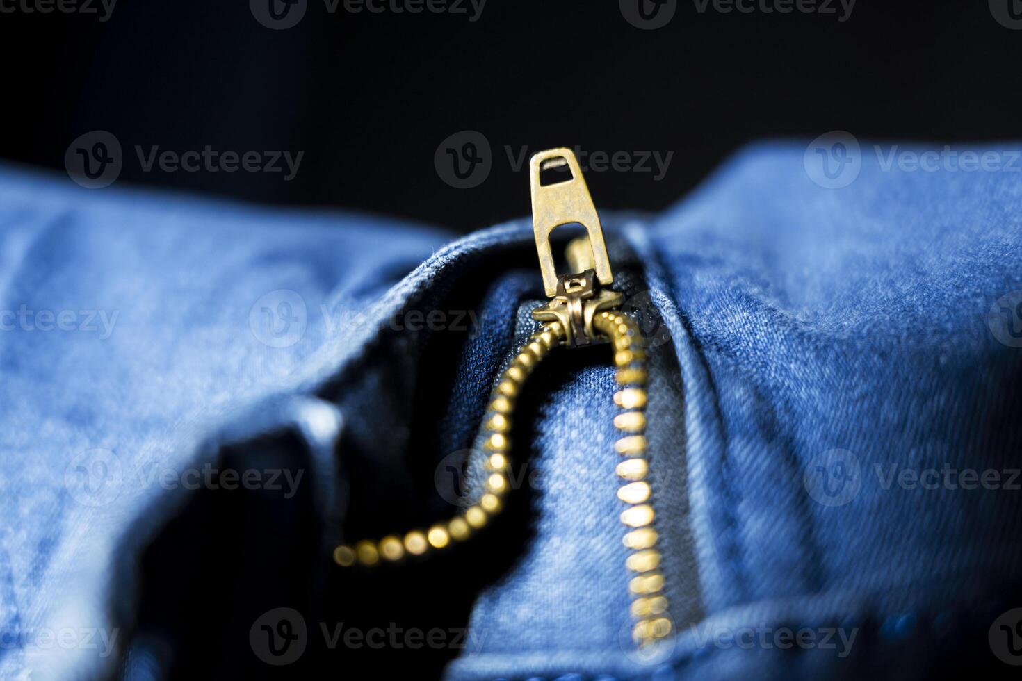 Close-Up of Zipper on Blue Jeans, Functional Denim Detail photo