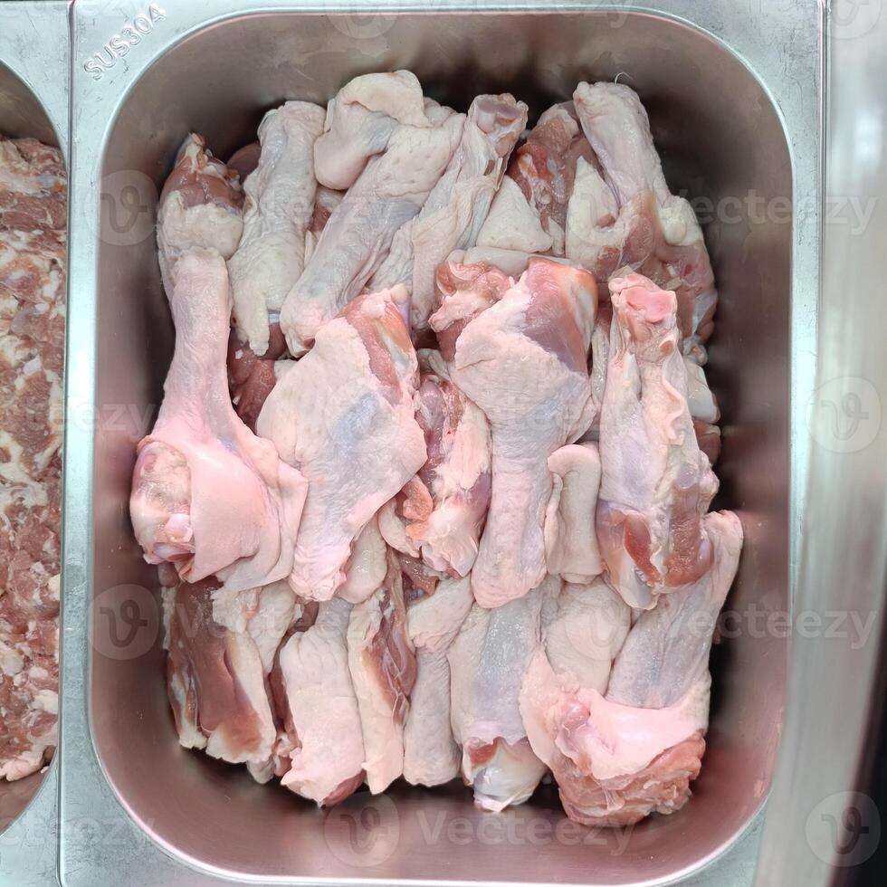 raw duck wings stick on stainless tray photo