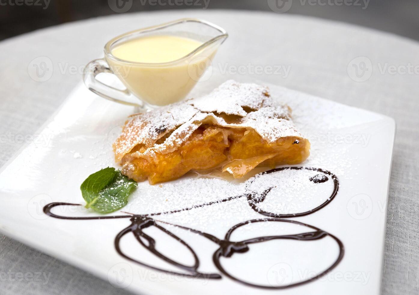 A dessert on a white plate with a sauce photo