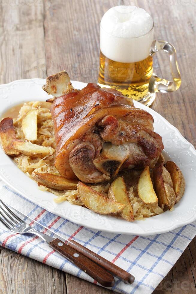 A plate of food with a beer and fork photo