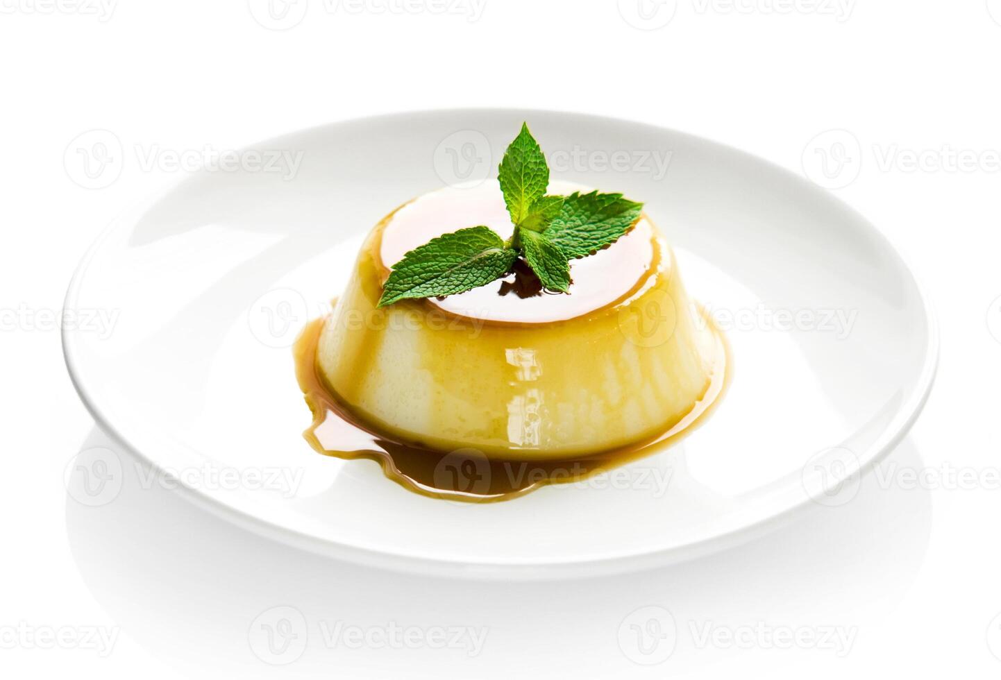 Flan with caramel sauce on white plate photo