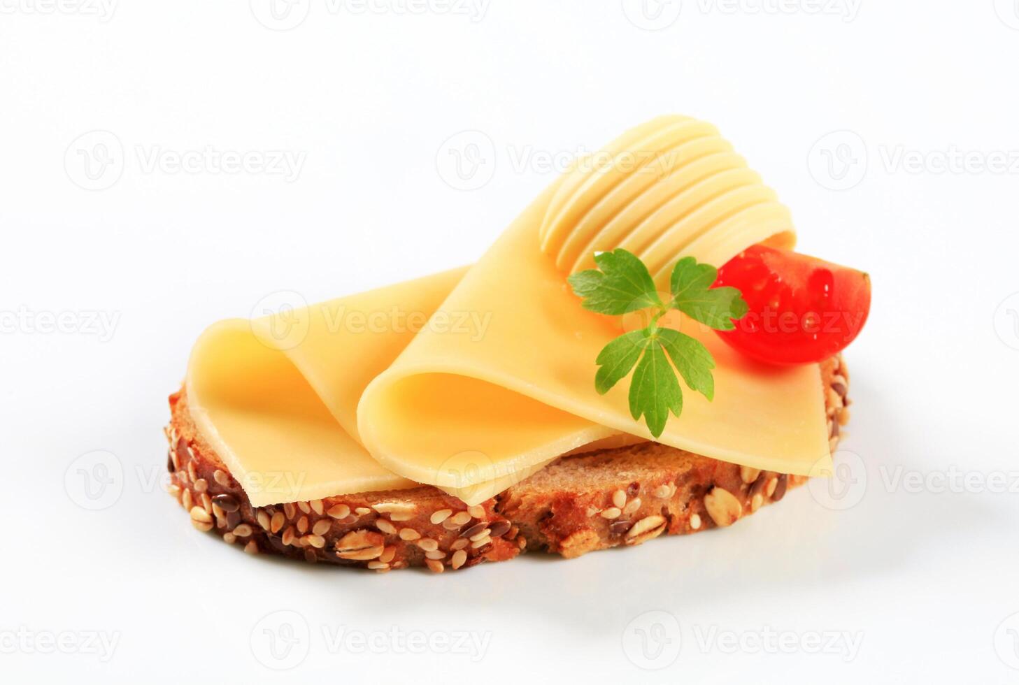 Cheese and tomato sandwich on bread with a leaf of parsley photo
