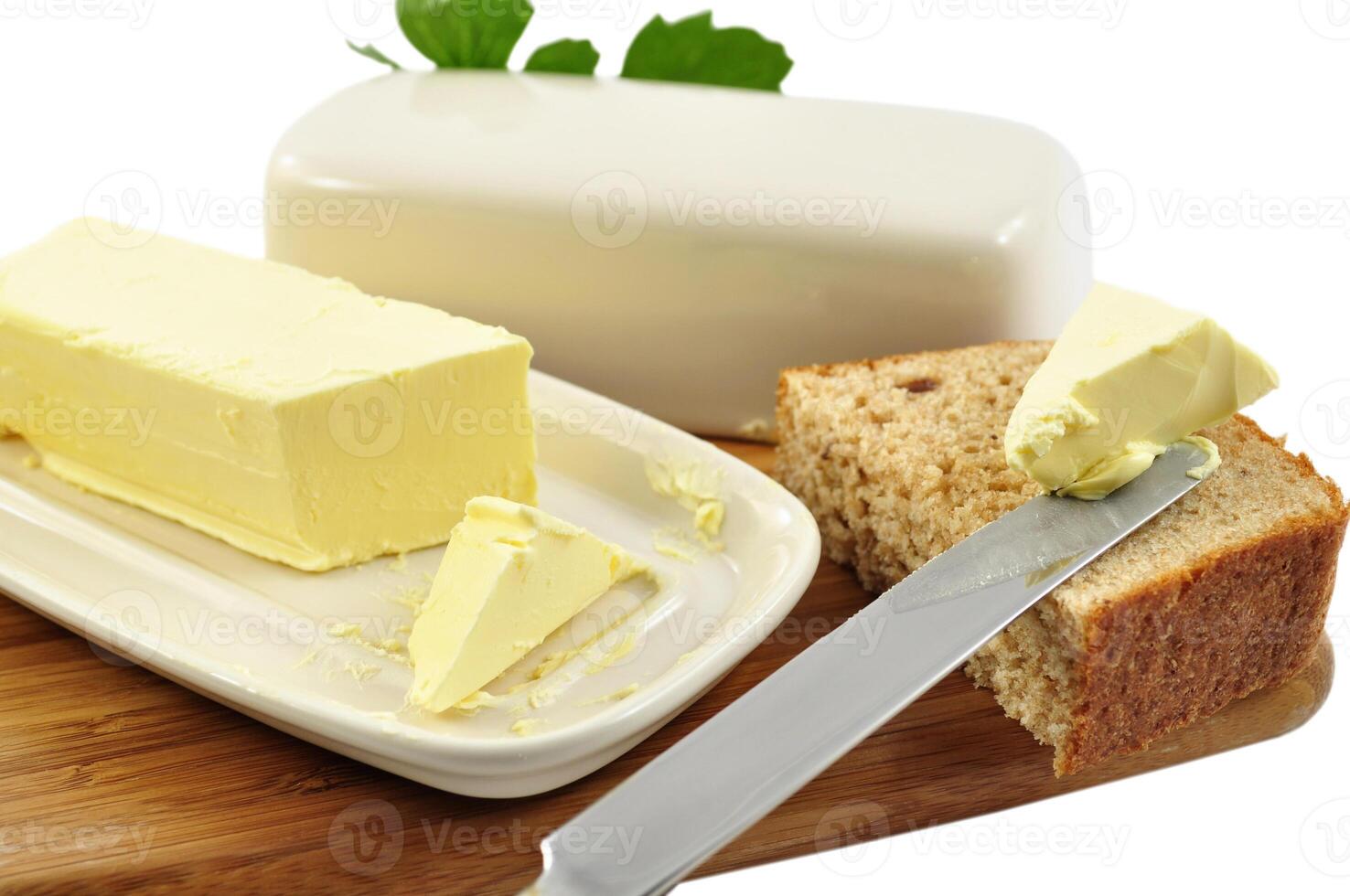 Butter on a cutting board with a knife photo