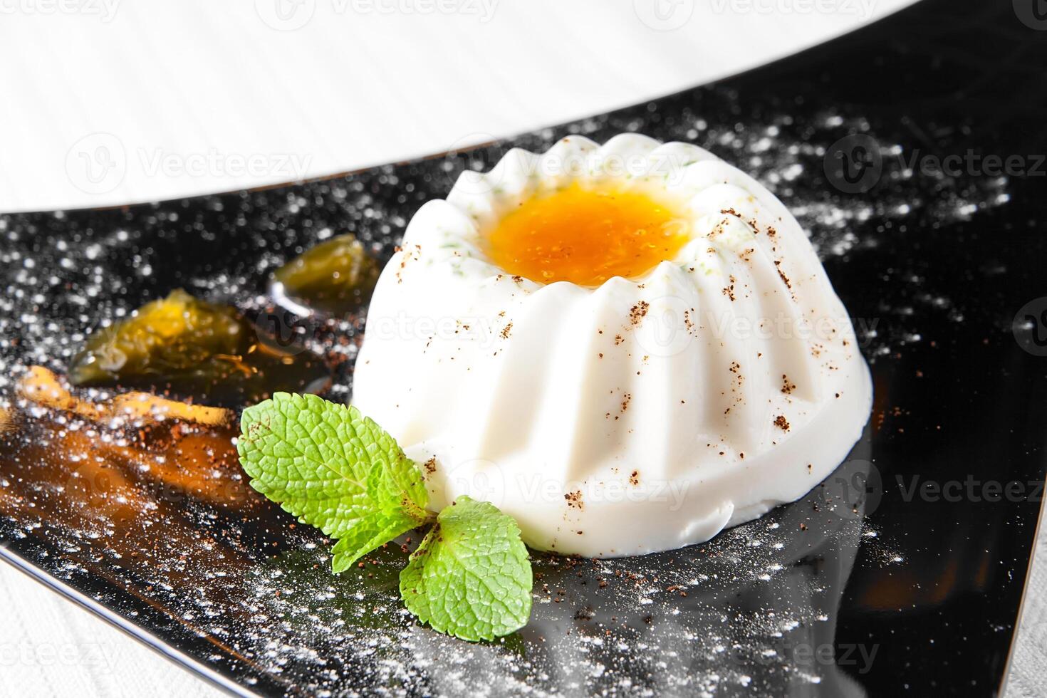 A dessert with an egg on top and some mint leaves photo