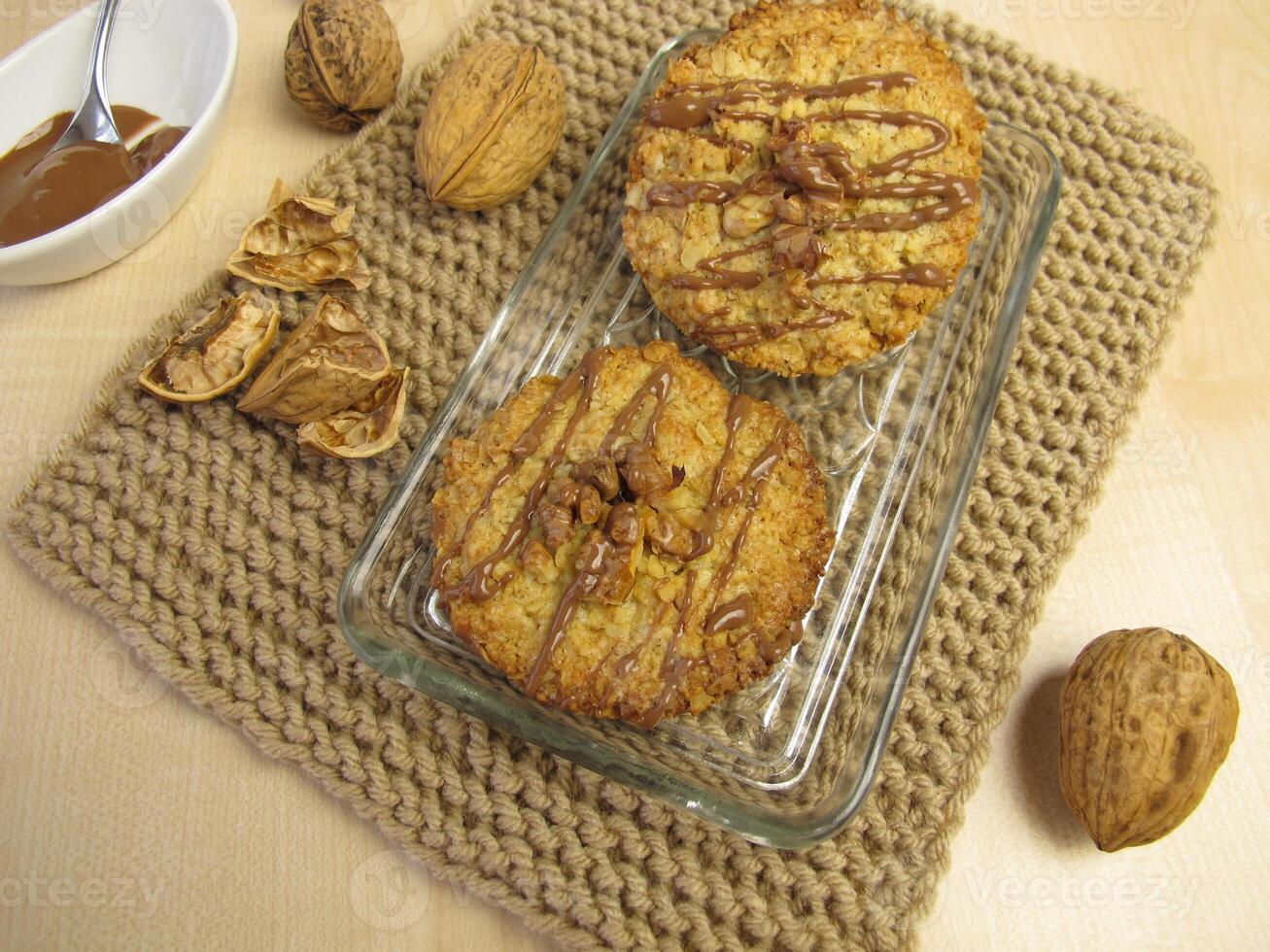 A plate with two donuts and a bowl of nuts photo