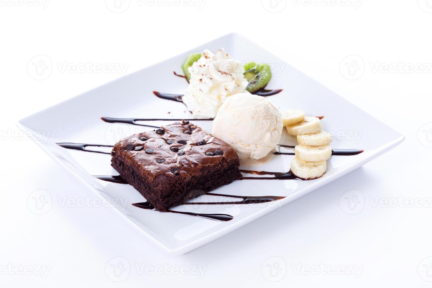 A square plate with a piece of cake, ice cream, and bananas photo