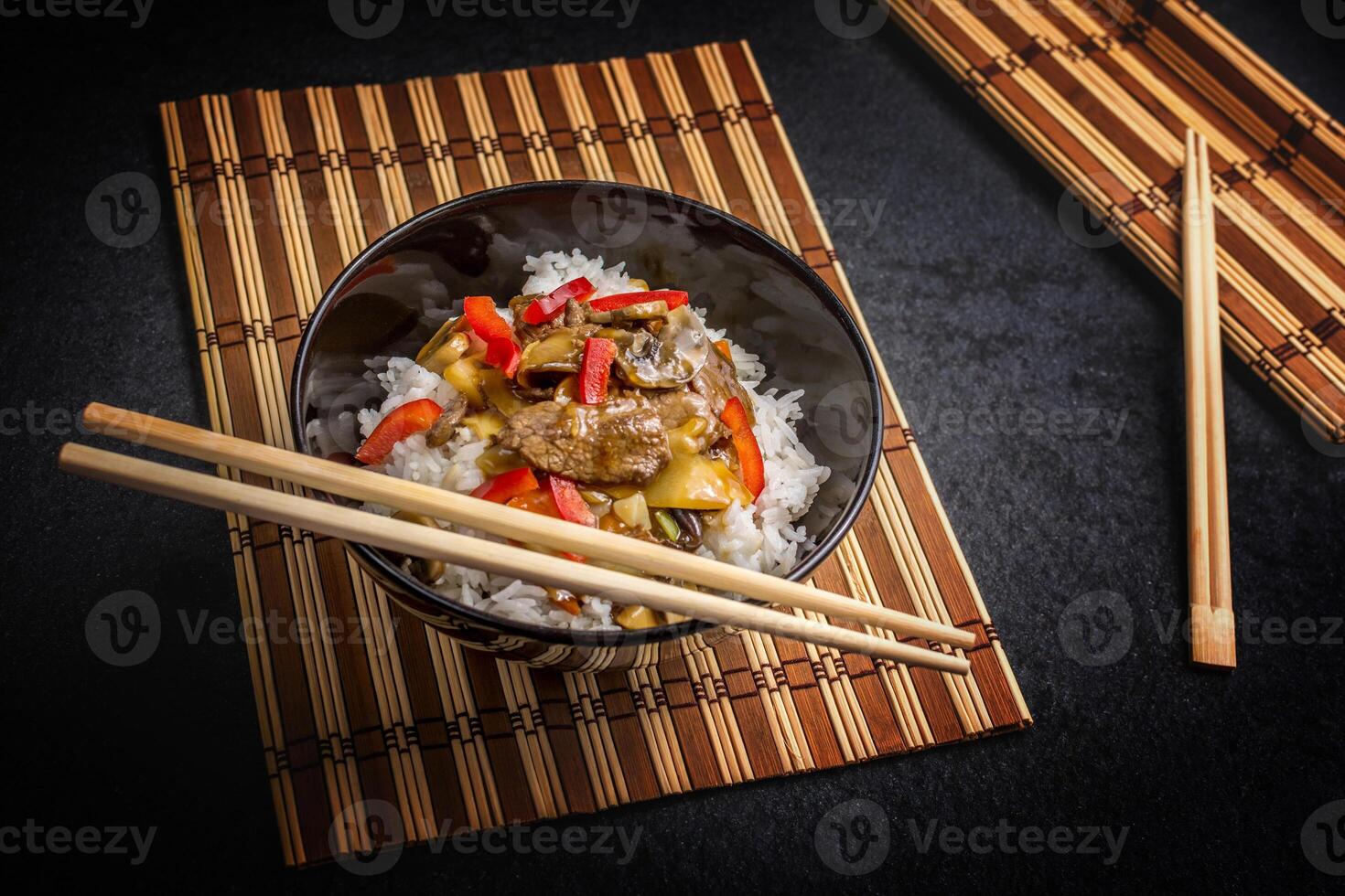 Chopsticks and rice in a bowl with chopsticks photo