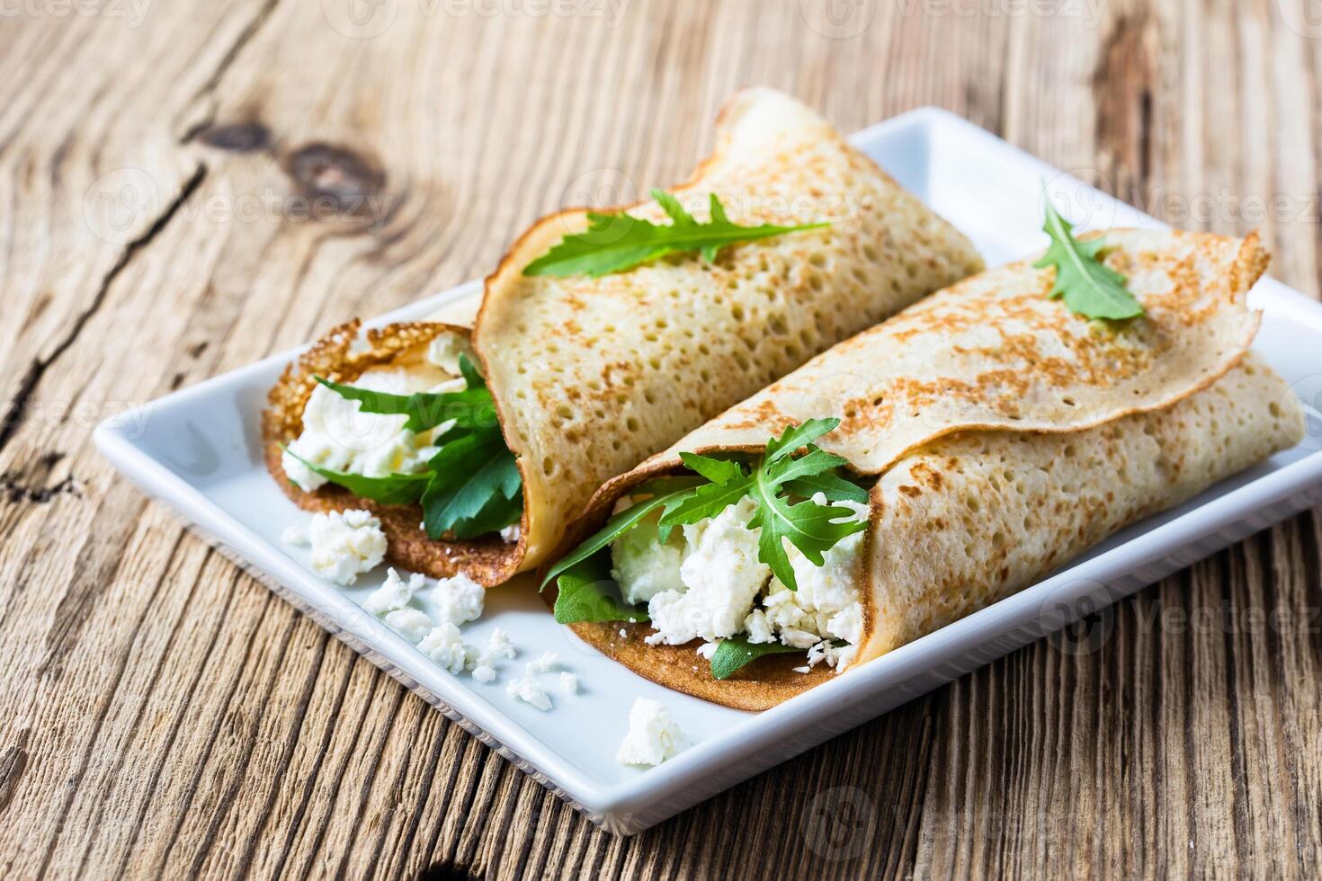 Crepes with arugula and cheese photo