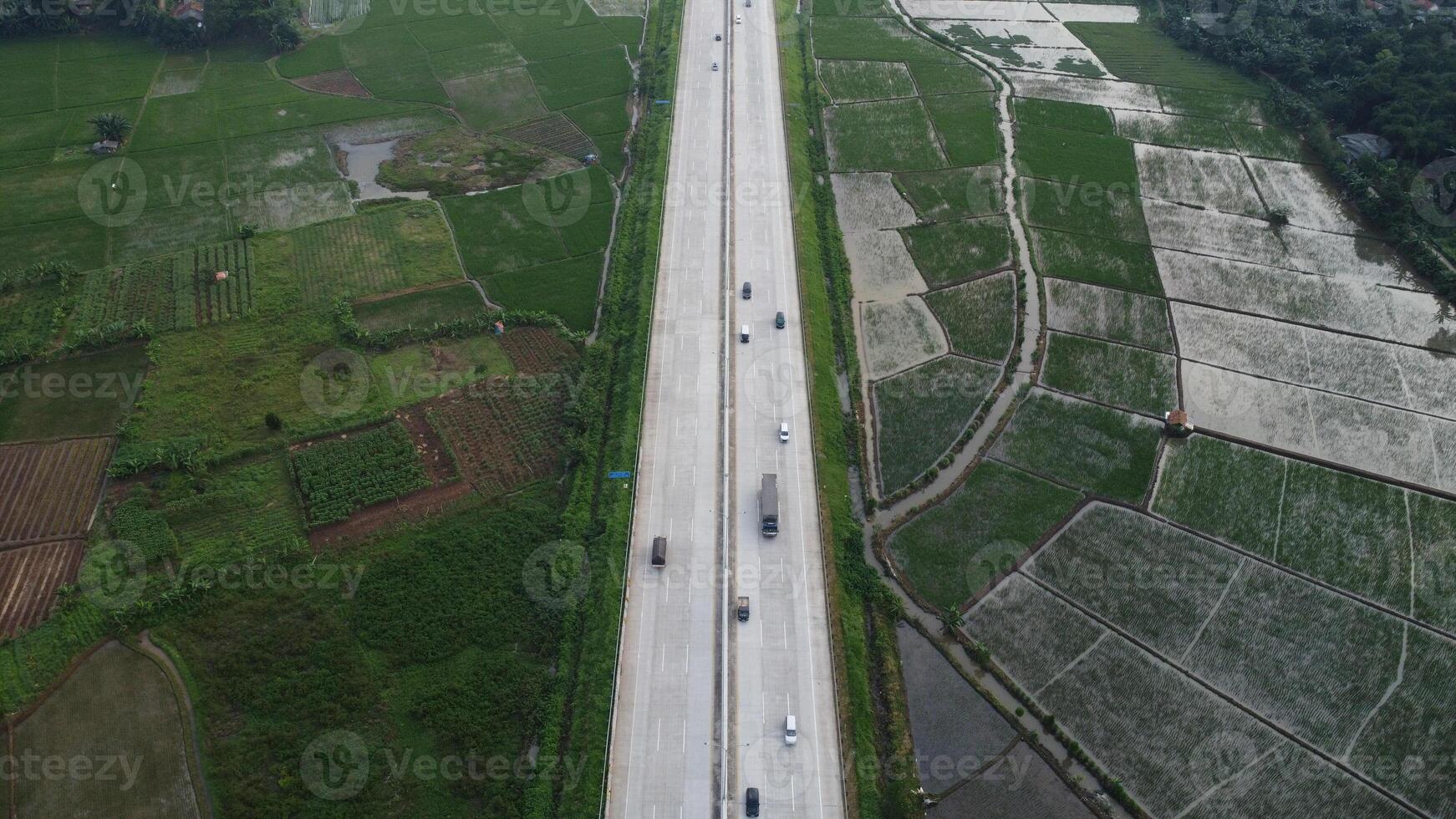 Urban landscape of cars driving on a highway with blurred motion capturing the speed of travel on the asphalt road at dusk photo