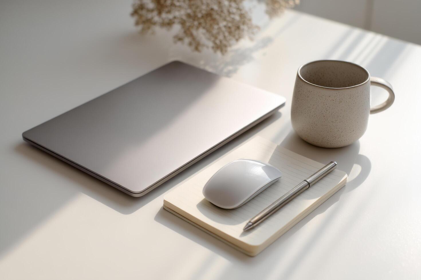 Modern Minimalist Workspace Setup Laptop, Notebook, and Cozy Mug on a Clean White Desk. Perfect for Productivity and a Serene Work from Home Atmosphere. photo