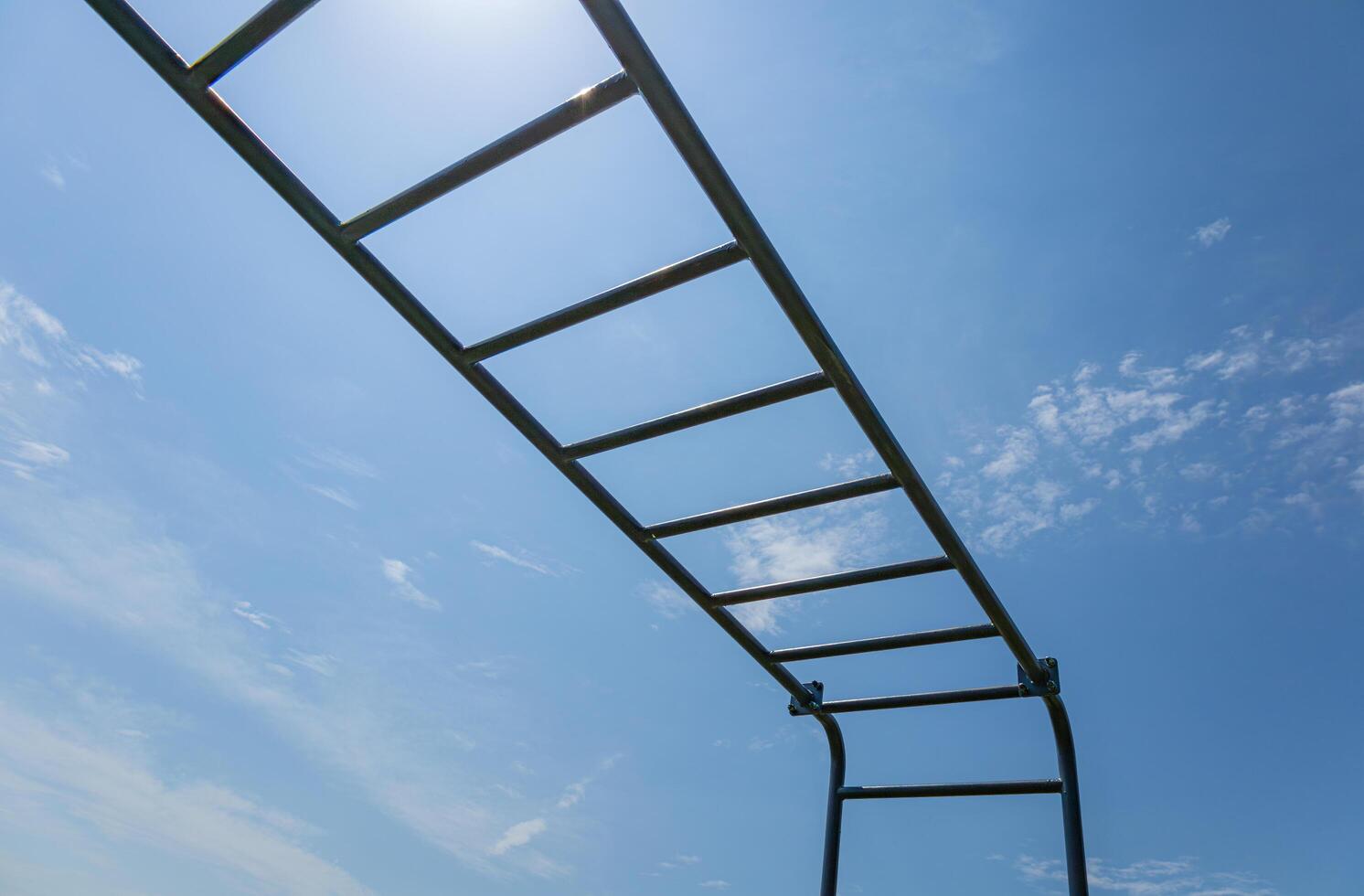 Athletes engage in training on a parallel horizontal bar, showcasing strength and skill while enjoying a sunny day outdoors photo