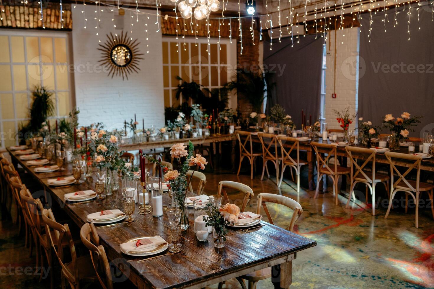 Elegant rustic wedding reception with floral arrangements and ambient lighting photo