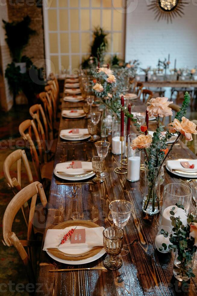 Elegant rustic wedding table setting with flowers and candles in cozy ambiance photo