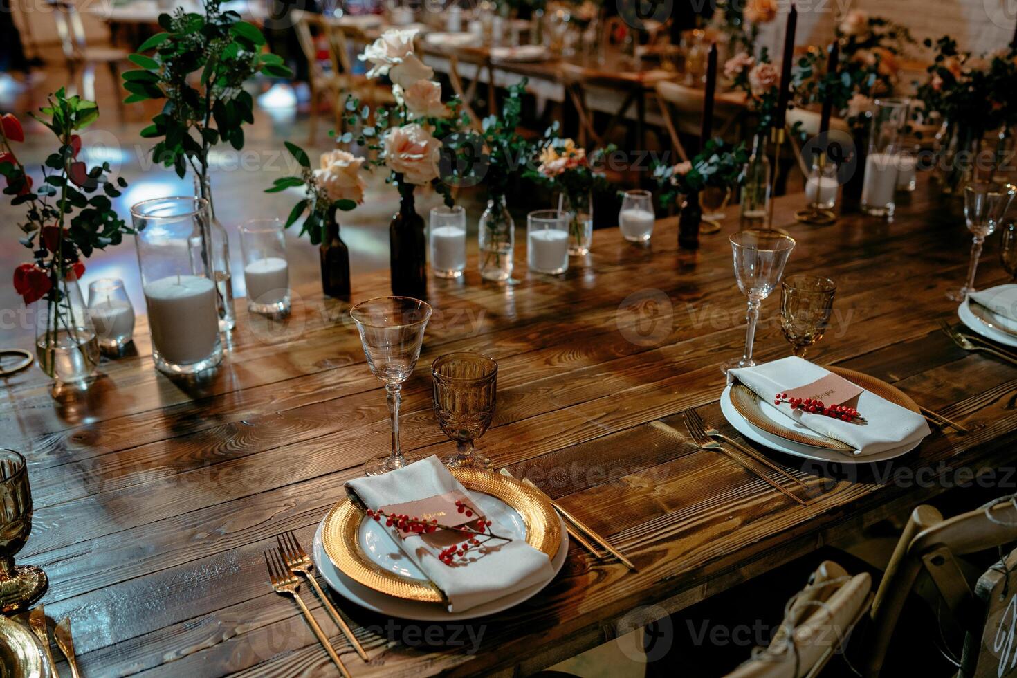 Elegant rustic wedding reception table setting with gold accents and floral decor photo