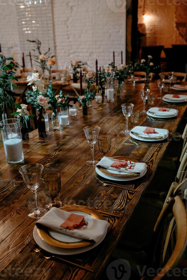 Elegant rustic wedding reception setup with floral centerpieces and candlelit ambiance photo