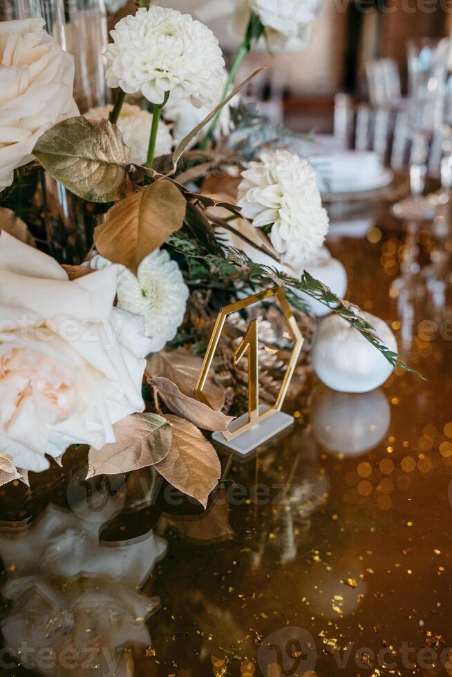 Elegant table setting with white flowers and gold decoration for special occasions photo