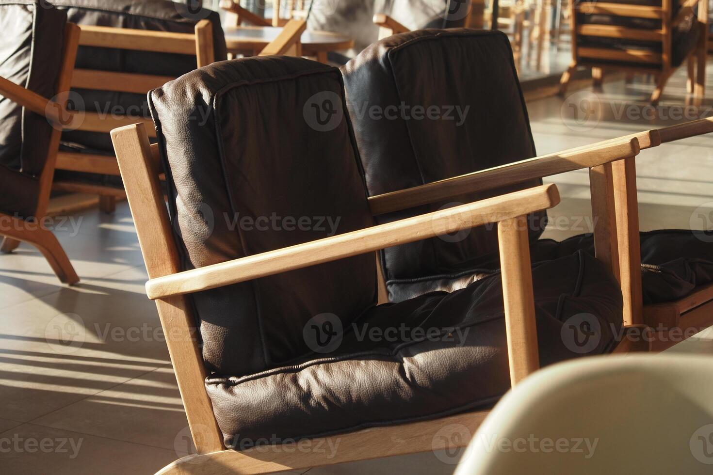 Comfy wooden chairs in a modern cafe setting photo
