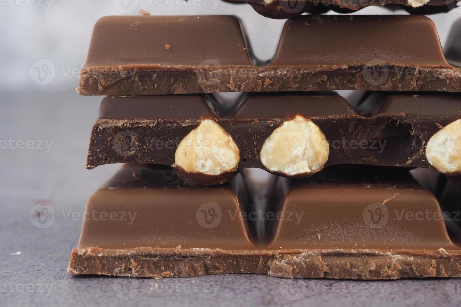 Chocolate bars with nuts stacked for a sweet treat photo