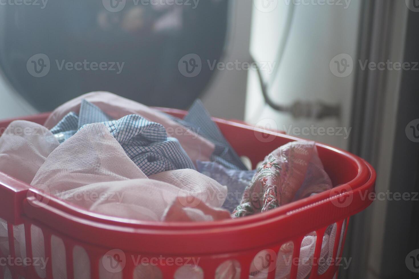 Laundry basket filled with clean clothes at home photo