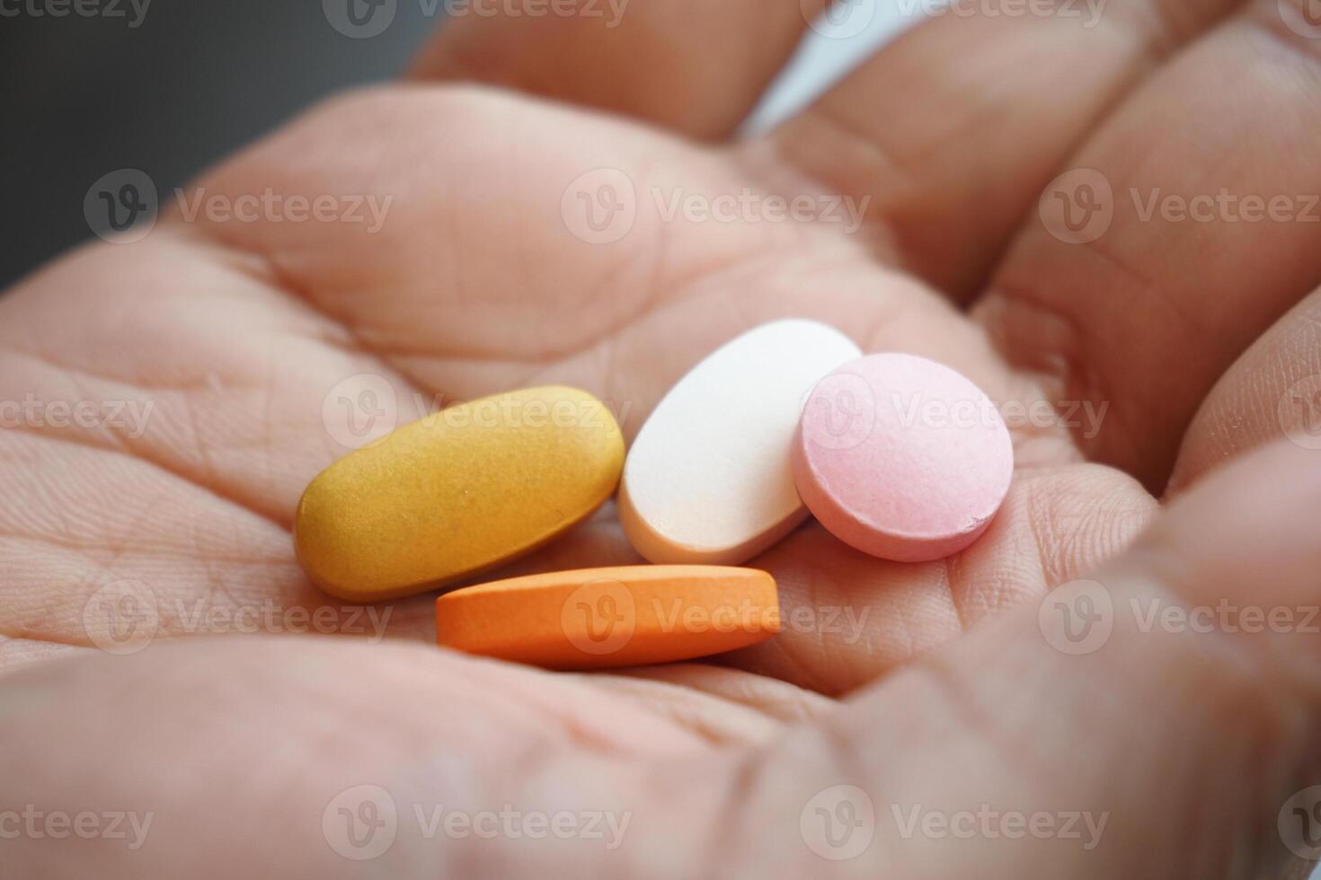 Holding various colored tablets in a palm photo
