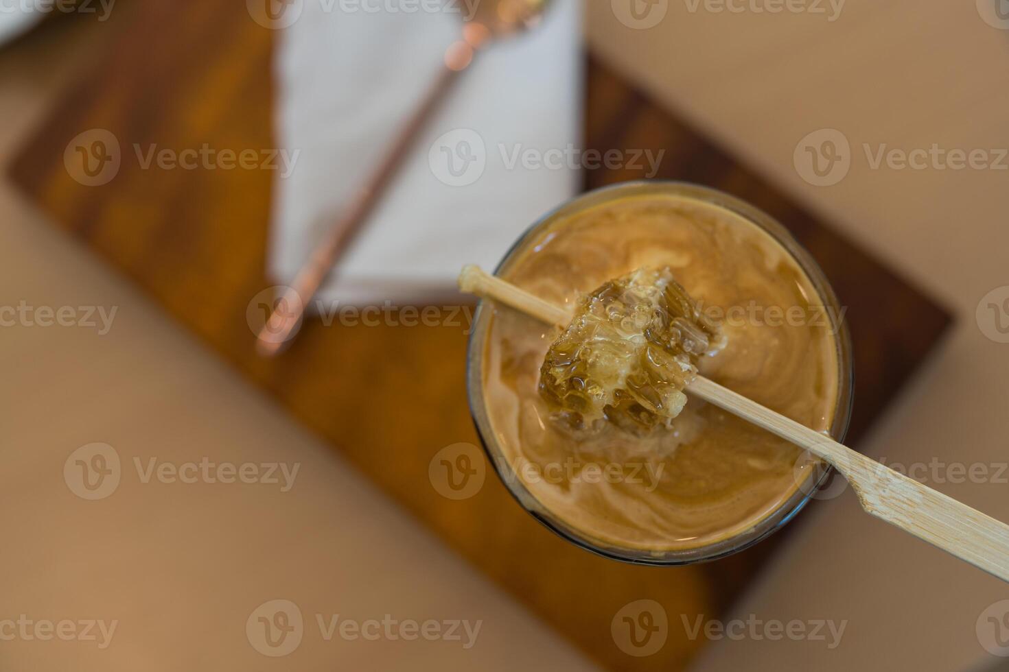 Close up photo of dirty coffee with piece honey on top