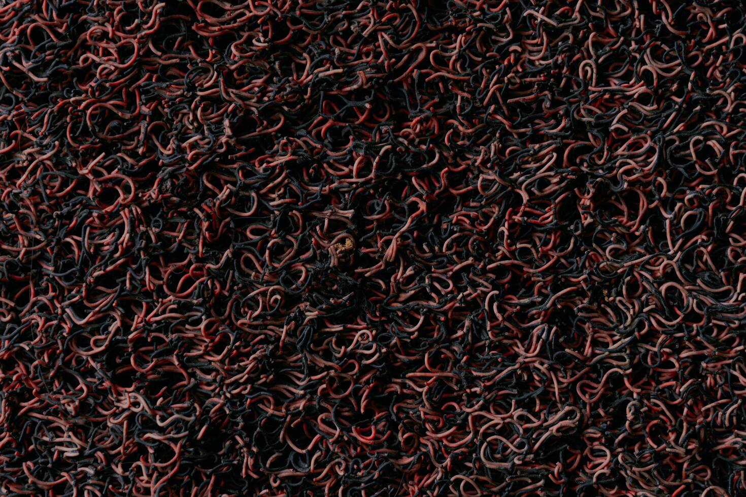 Texture of dark old red and black vinyl carpet. photo