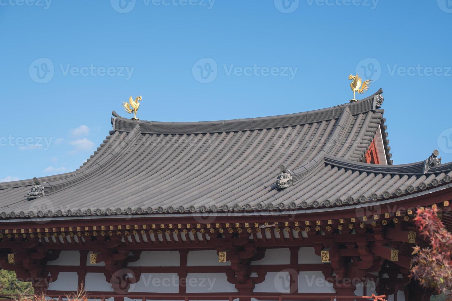 Byodo-in Temple Uji Kyoto Japan, Traditional Asian temple roof under a clear blue sky. photo