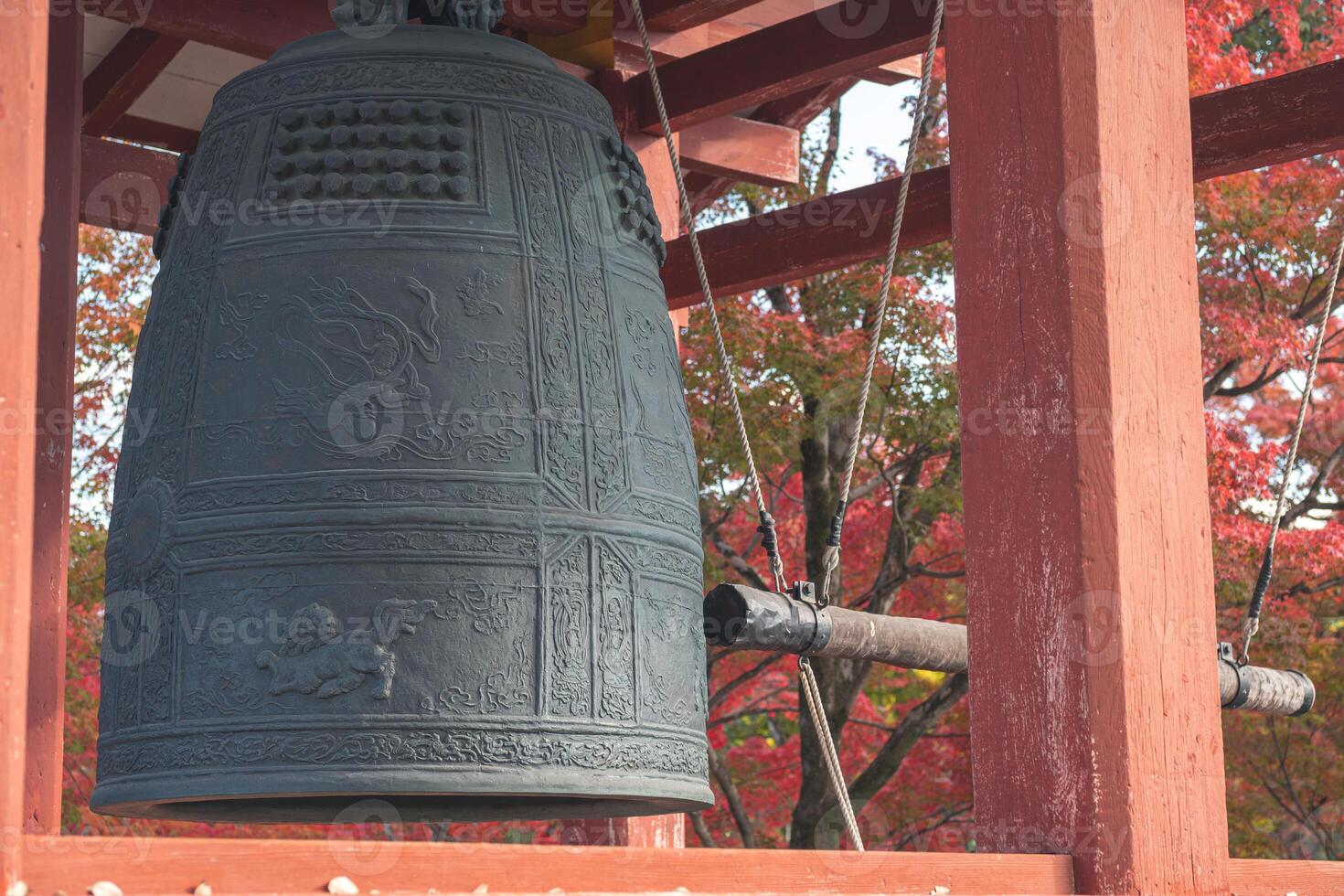 Byodo-in Temple Uji Kyoto Japan, Ancient bell hanging in a wooden structure surrounded by nature. photo