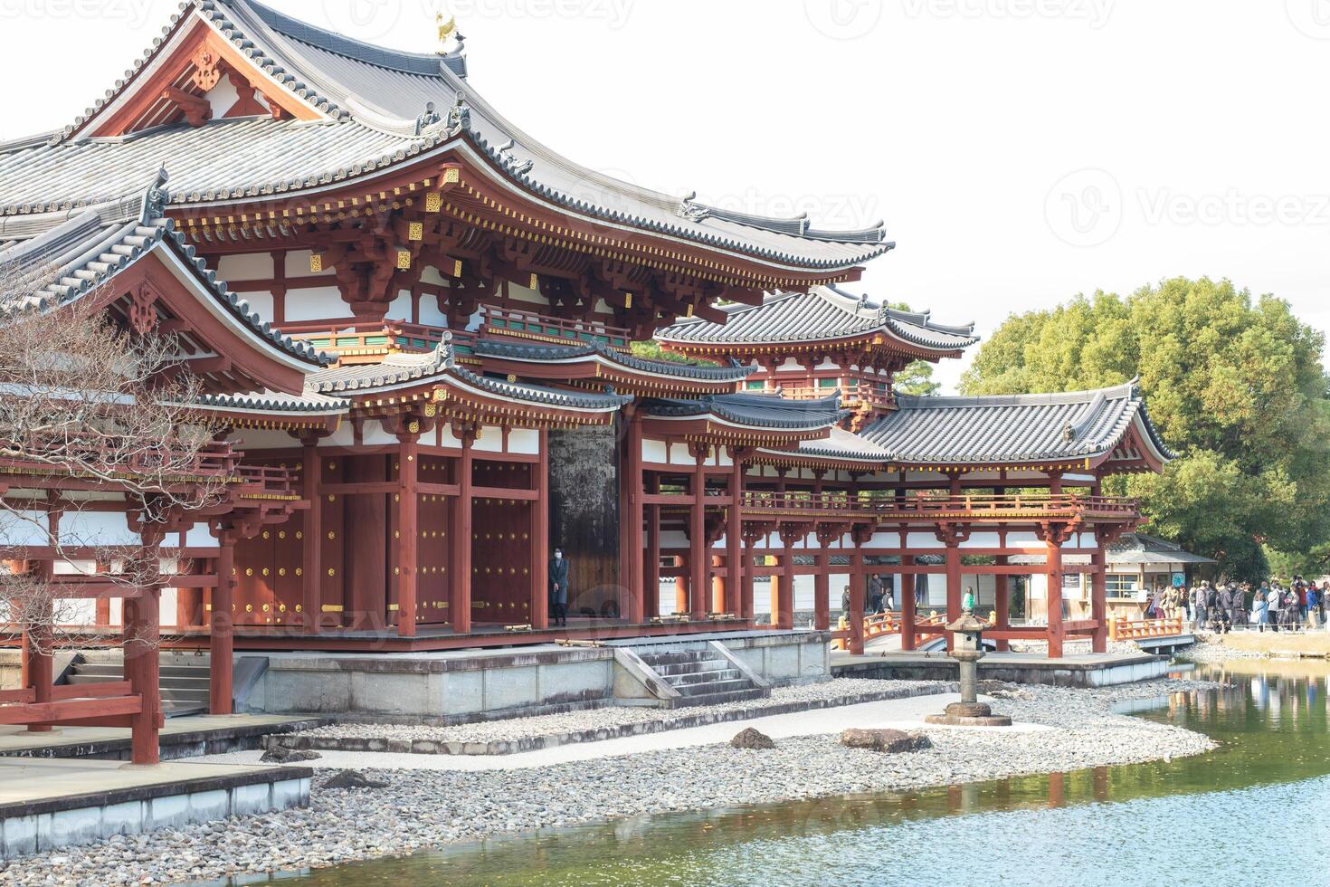 Byodo-in Temple Uji Kyoto Japan, Traditional Asian architecture by a serene waterway. photo