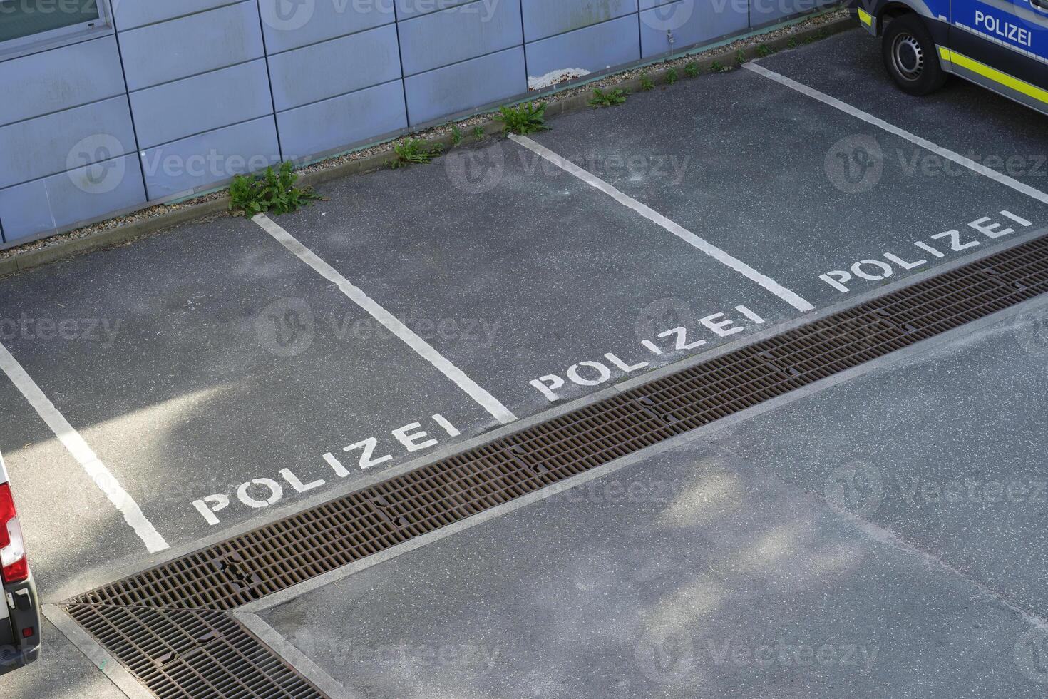 Parking spaces are reserved for the German police on a tiled wall, three parking spaces are free photo