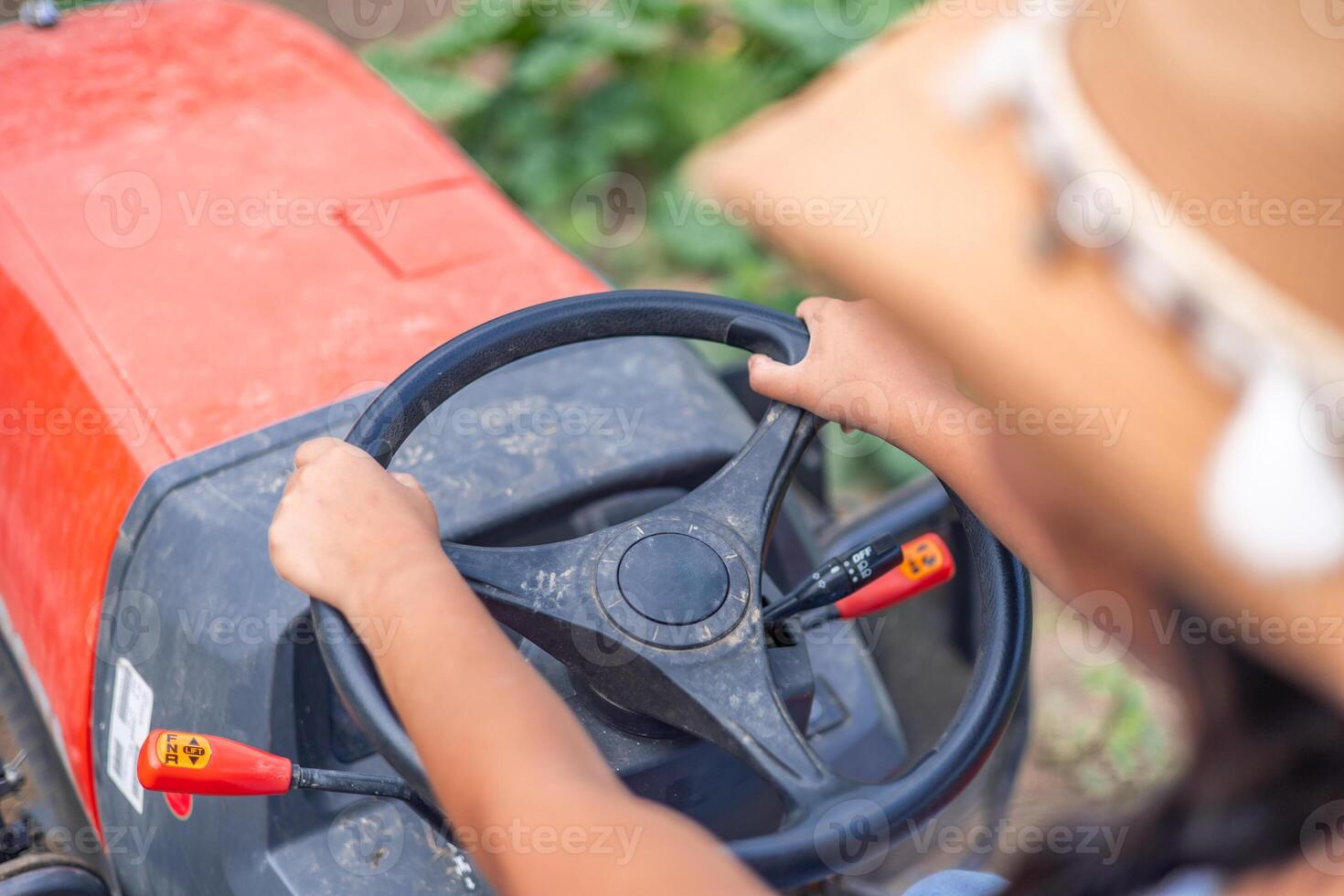 Latin farmer woman driving a tractor in the field photo