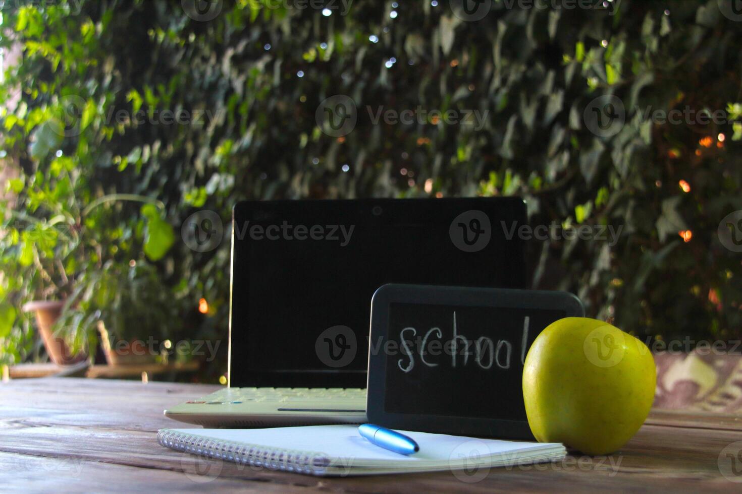 Back to school concept.There is a laptop and a school sign on the table. photo