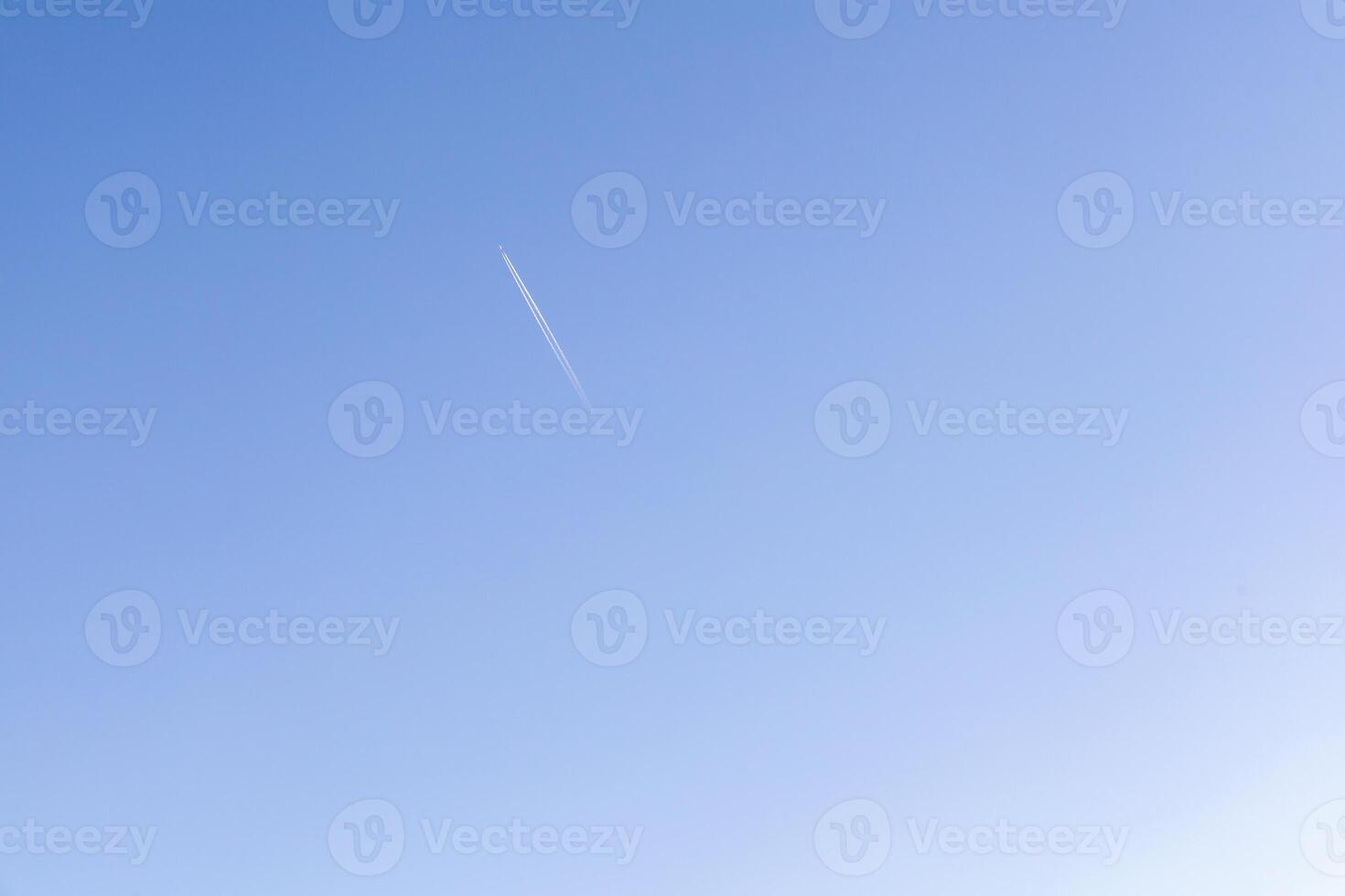 A single jet plane flying on the beautiful blue sky photo