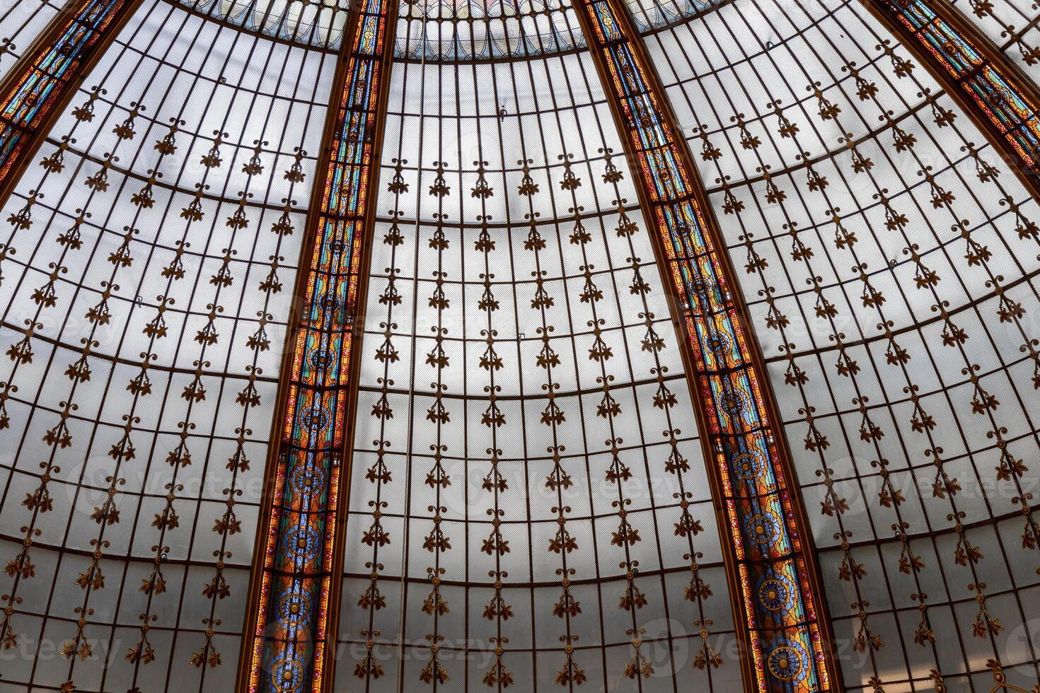 An Intricate and Stunning Stained Glass Dome Design. Galeries Lafayette Paris, France photo